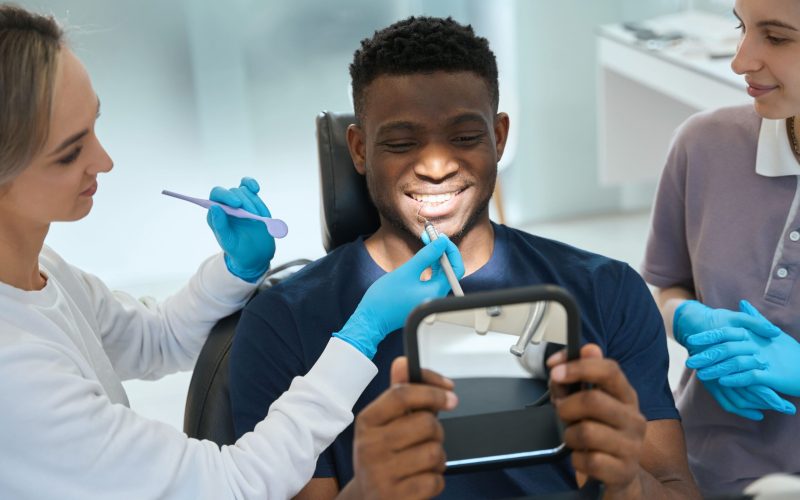 african-american-client-sitting-on-dental-chair-an-2024-10-18-13-40-26-utc