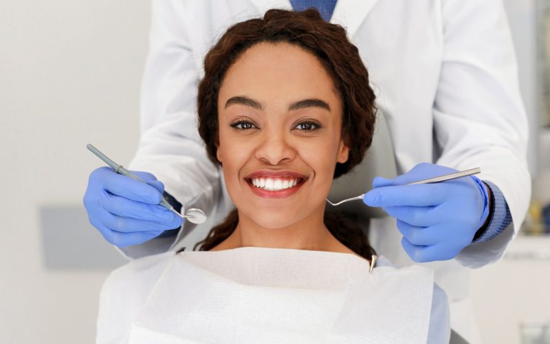 cheerful-african-woman-and-dentist-staying-behind-2025-03-18-18-29-52-utc